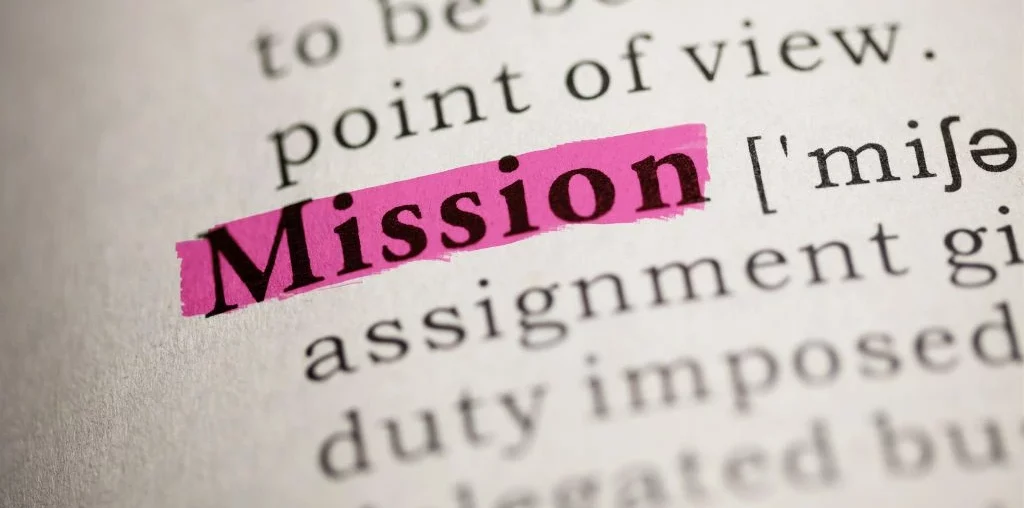 A closeup photo of the word mission highlighted on a dictionary.