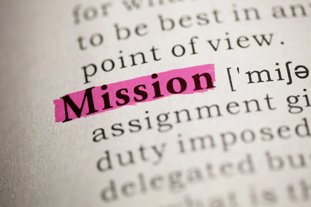A closeup photo of the word mission highlighted on a dictionary.