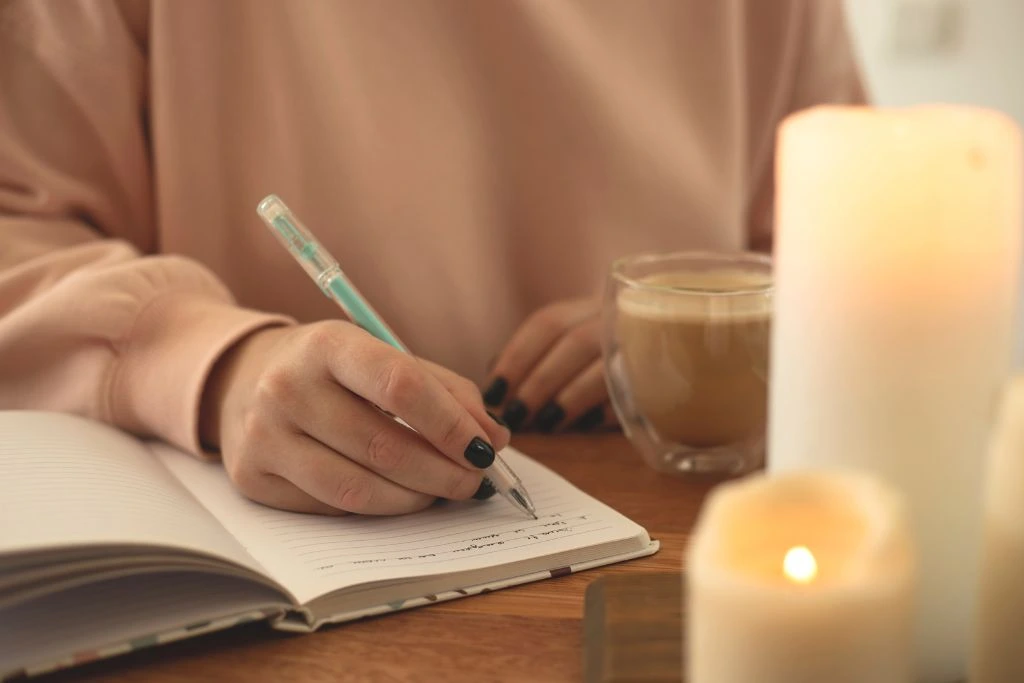 A person writing on her journal