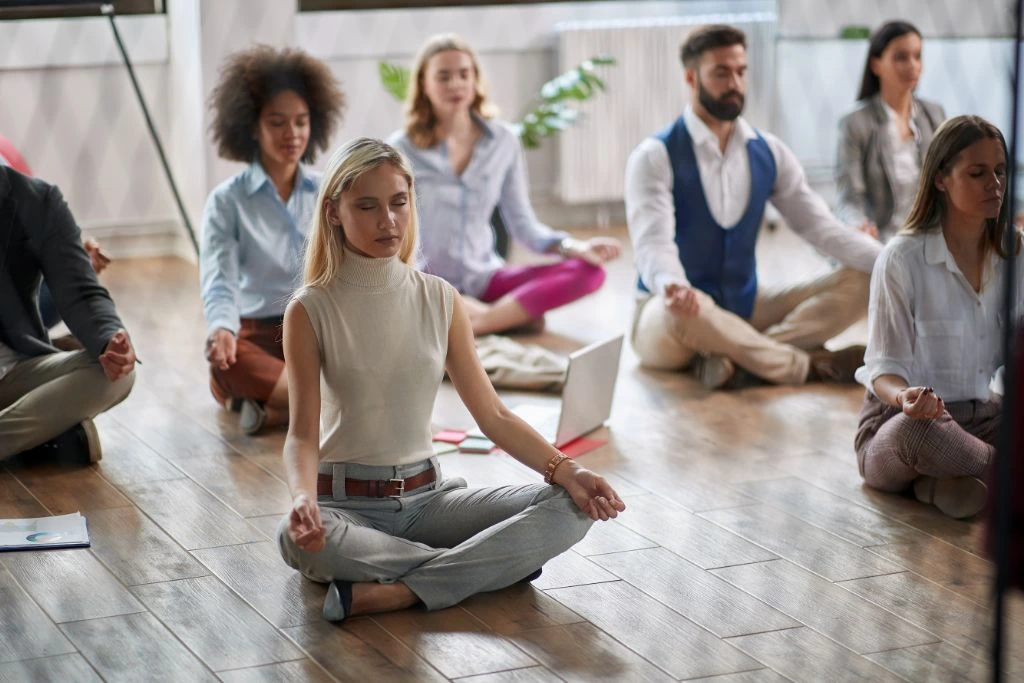 group of people meditating at work