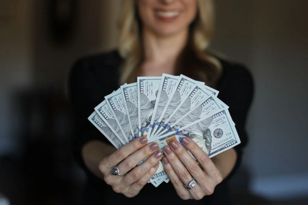 A woman holding a lot of money