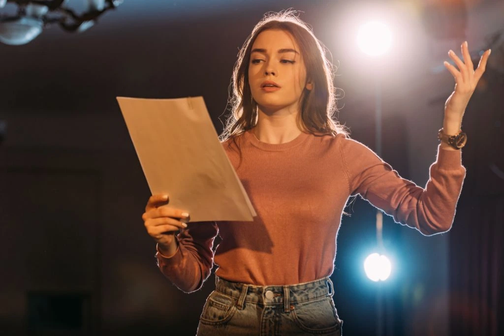 A beautiful actress rehearsing her lines while holding the script