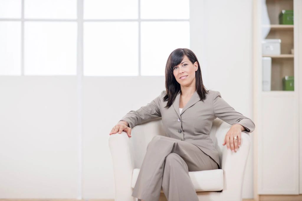 A corporate woman woman sitting on a chair