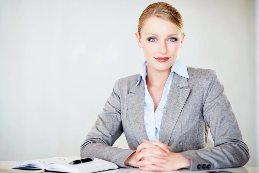 A corporate woman sitting at her desk