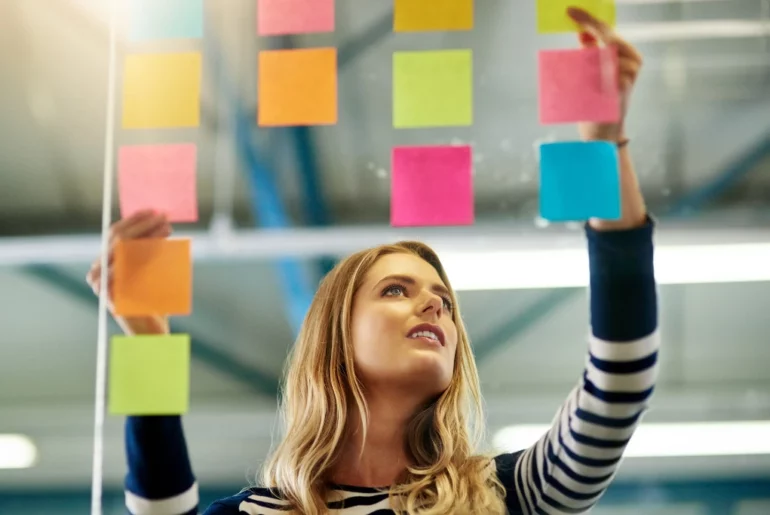female choosing between sticky notes