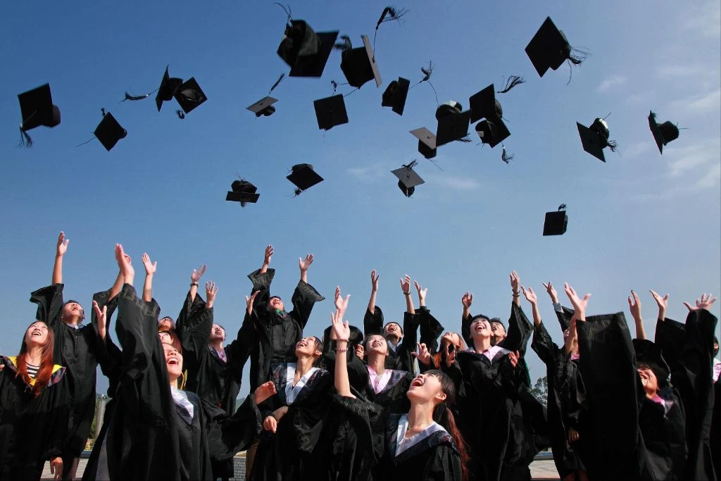 graduates throwing their caps