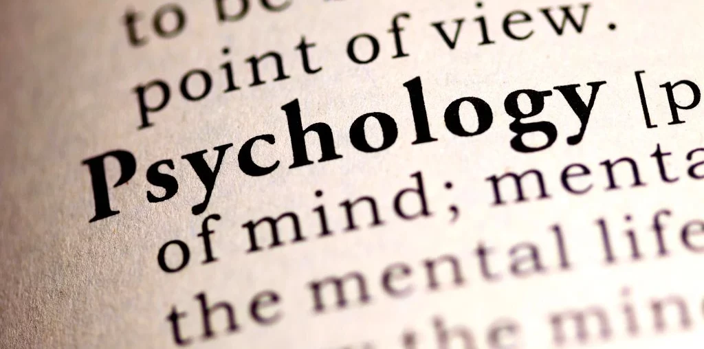 psychology word in bold format written in brown paper