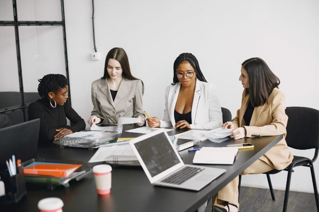 Professional women are having their work meetings inside their office
