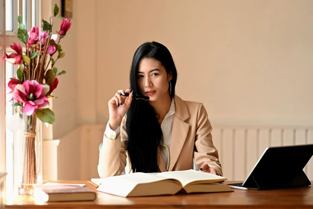 A female editor entrepreneur works diligently at her office's desk
