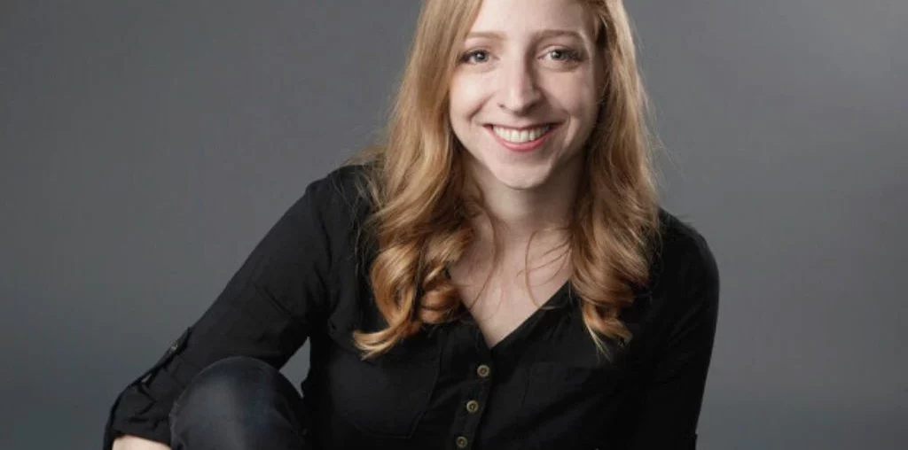 A picture of Becky Stern smiling on a gray background
