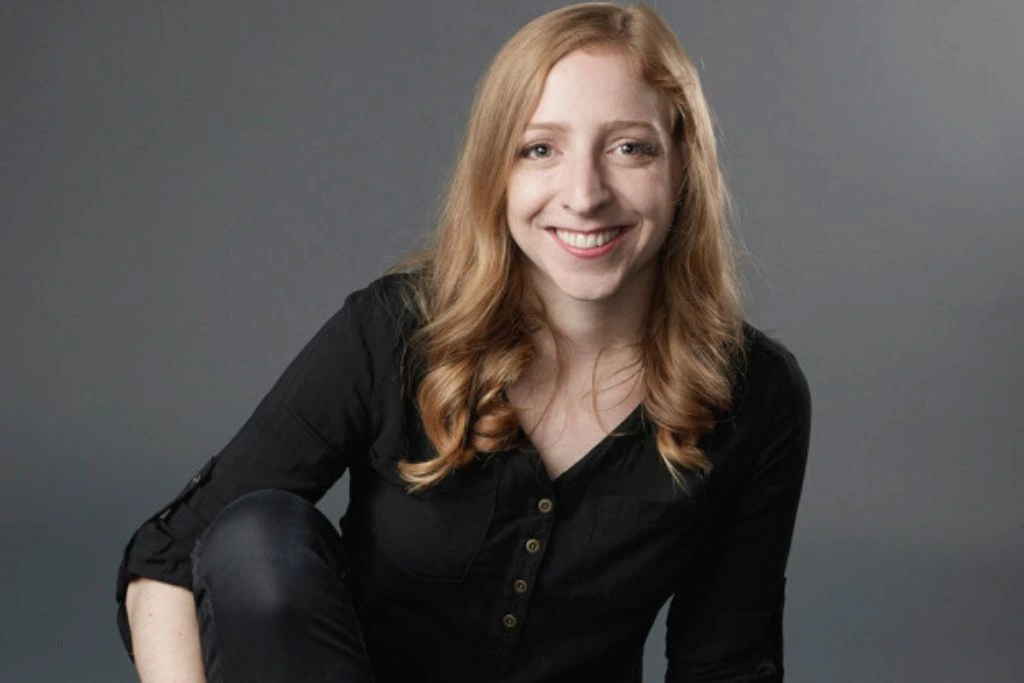 A picture of Becky Stern smiling on a gray background