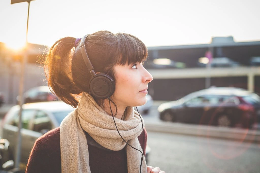 A woman wearing headphones at the streets