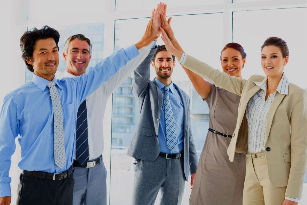 employees raising their hands sign of celebrating success