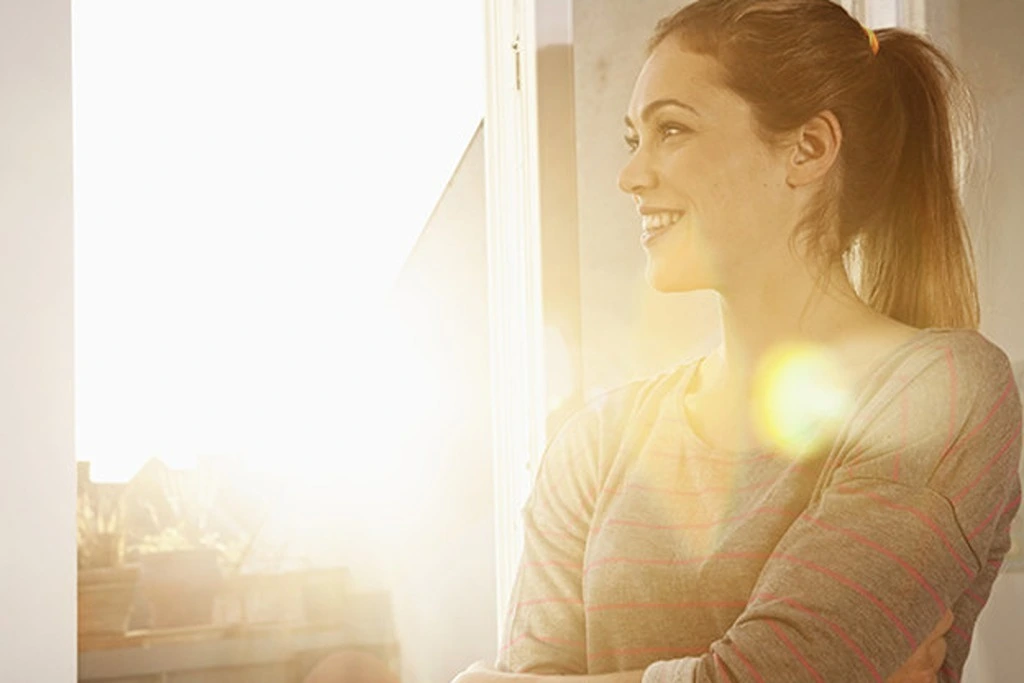 A woman smiling during sunrise
