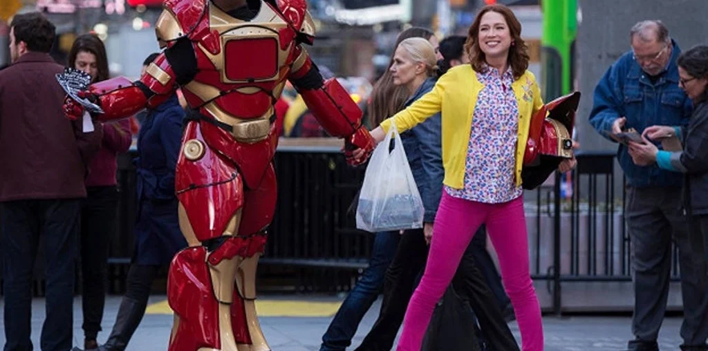 kimmy schmidt holding hands with an iron man cosplayer