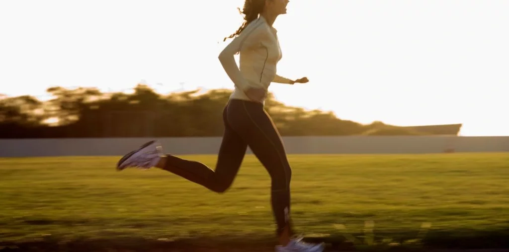 woman running on a track field