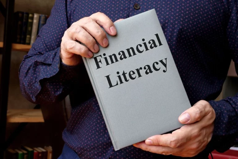 A man holding a financial literacy book