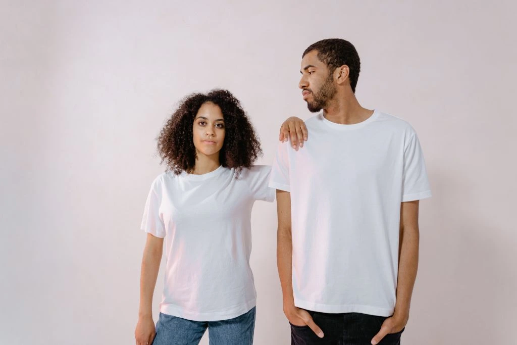 A man and woman standing in a grayish background