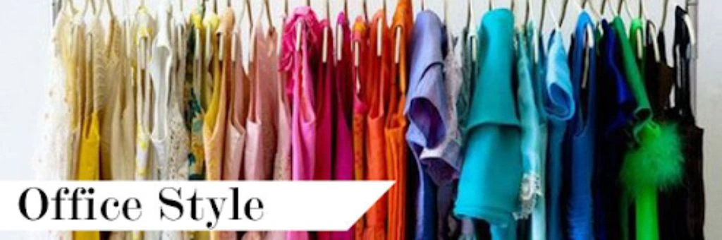 clothes hanging on a rack arranged by color