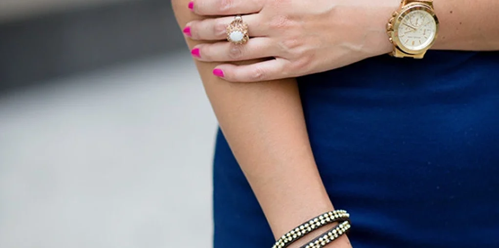 woman wearing earrings, watch, and bracelet
