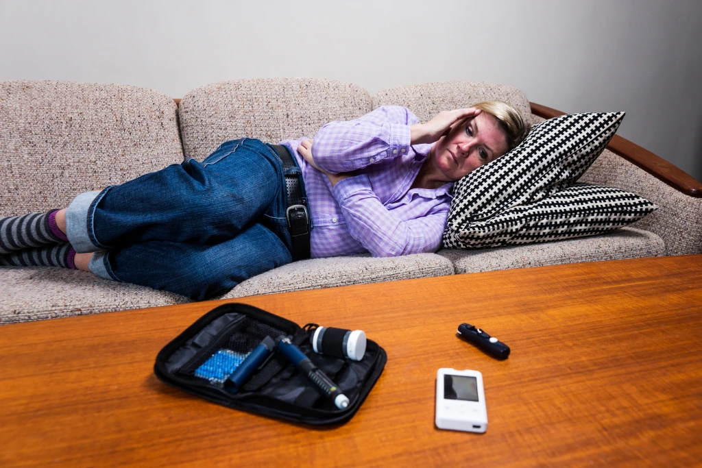 woman lying on a sofa experiencing a sugar crash