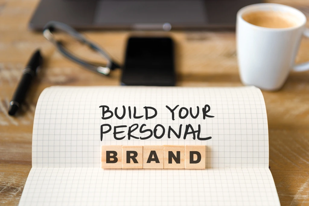 notebook with a build your personal brand message on it