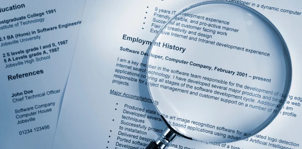 magnifying glass on top of a resume
