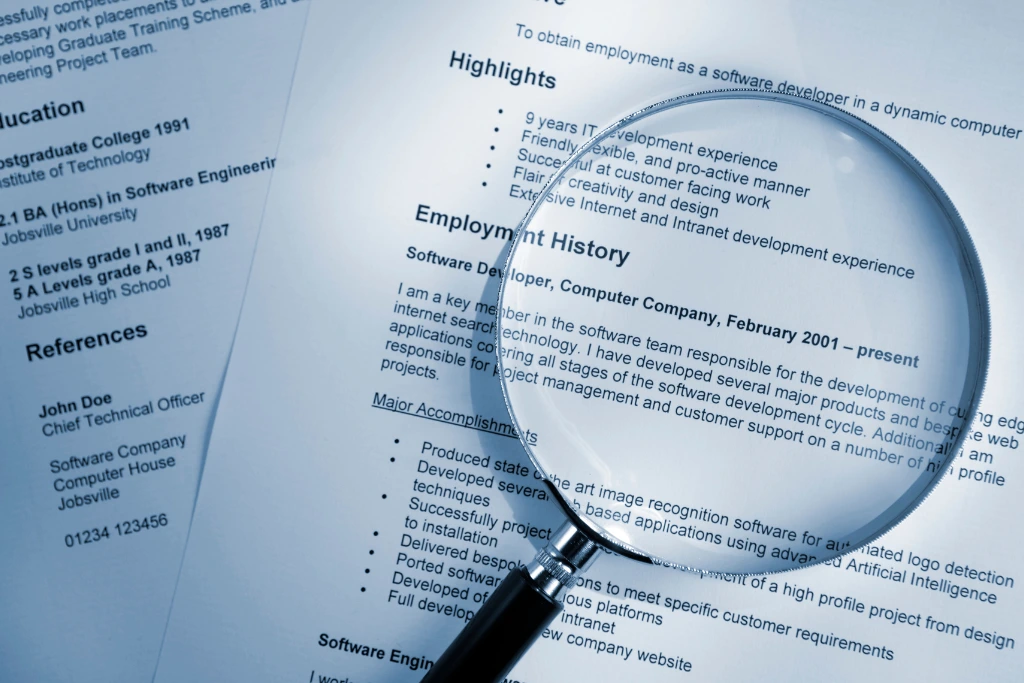 magnifying glass on top of a resume