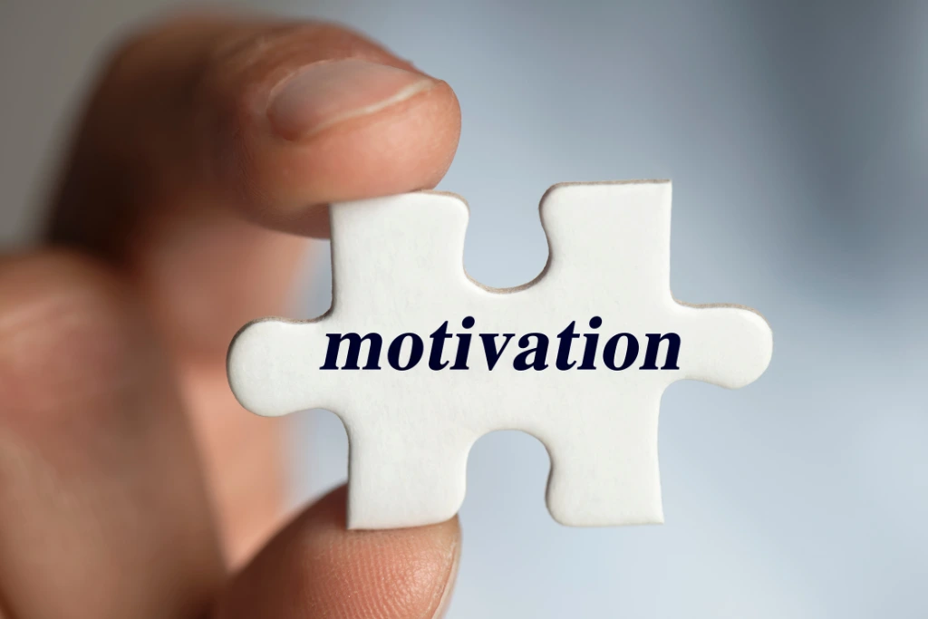 a puzzle piece with the word motivation printed on it