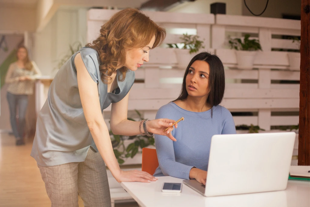 a woman giving advice to an intern