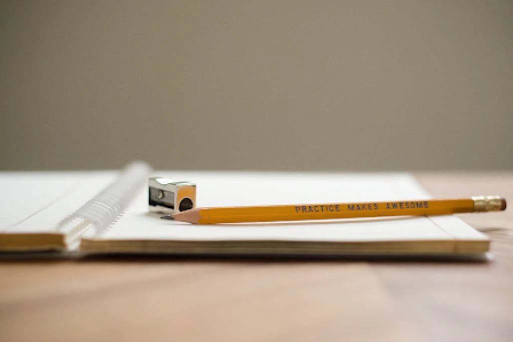 close up photo of notebook and pencil on a table