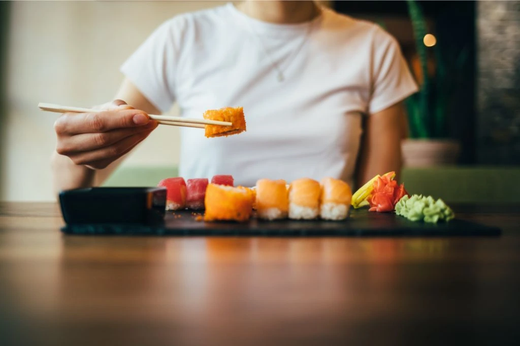 woman eating sushi alone