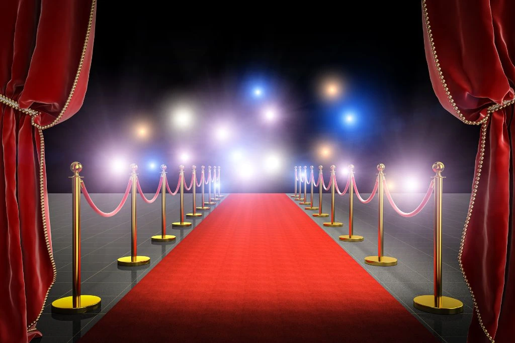 Red carpet with red curtains and lights.