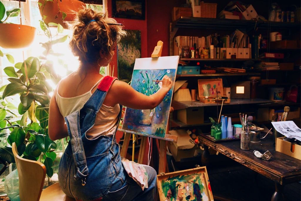 woman painting an artwork